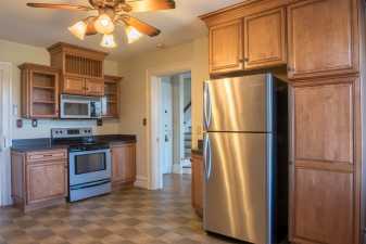 a kitchen with wooden cabinets