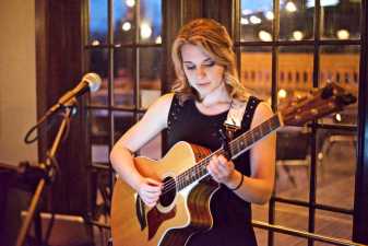 a young woman playing guitar