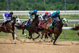 a horse race on a dirt track