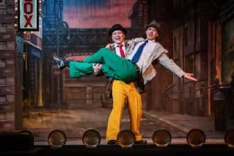 two young men on a stage performing