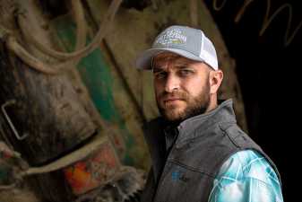 a farmer with a triple-m-farms hat