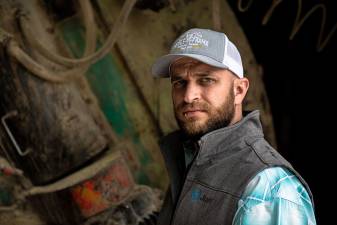 a farmer with a triple-m-farms hat
