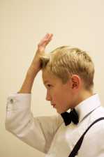 young boy spiking his hair for a black tie event
