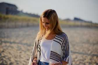 a smiling young woman on a beach