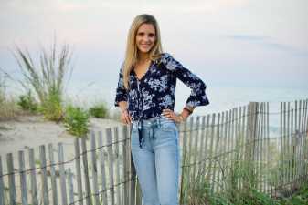 a smiling young woman on a beach