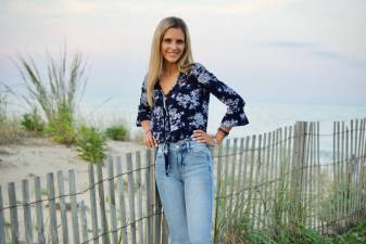 a smiling young woman on a beach