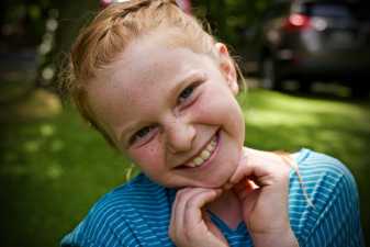 a young girl smiling