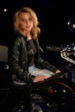 a young woman on a harley at night in her driveway