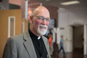 a pastor smiling at the camera