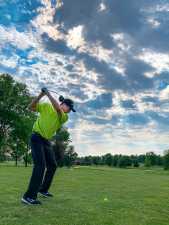 a man teeing off at a golf course