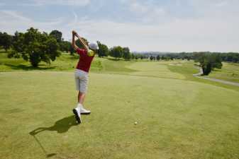 a young man getting ready to tee off at a golf course