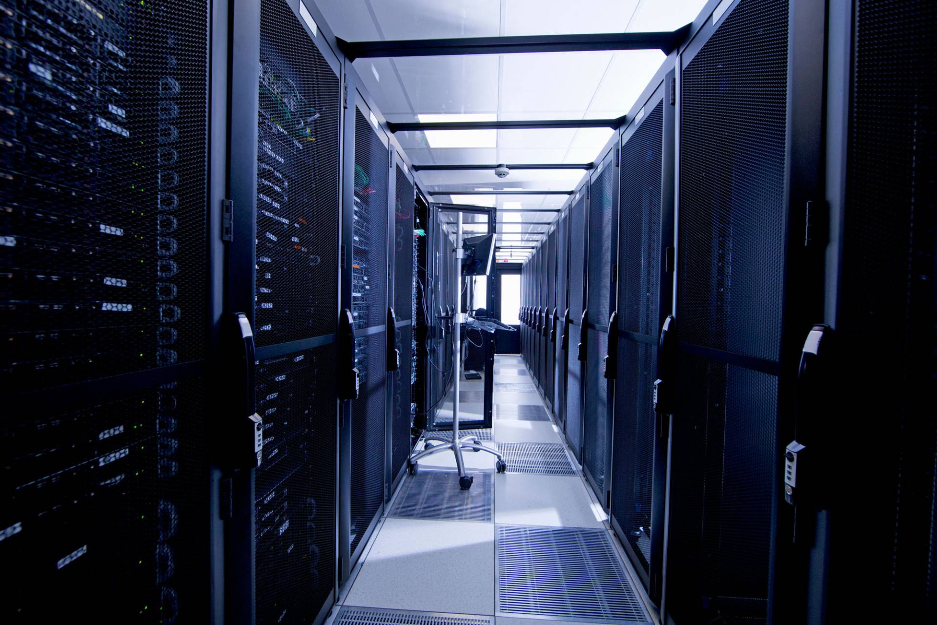 Server room aisle with blue lighting for alternative website management services