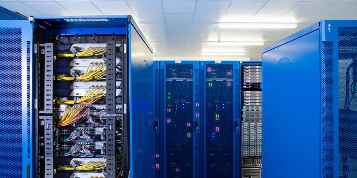 Server racks with blue cables powering managed web hosting services