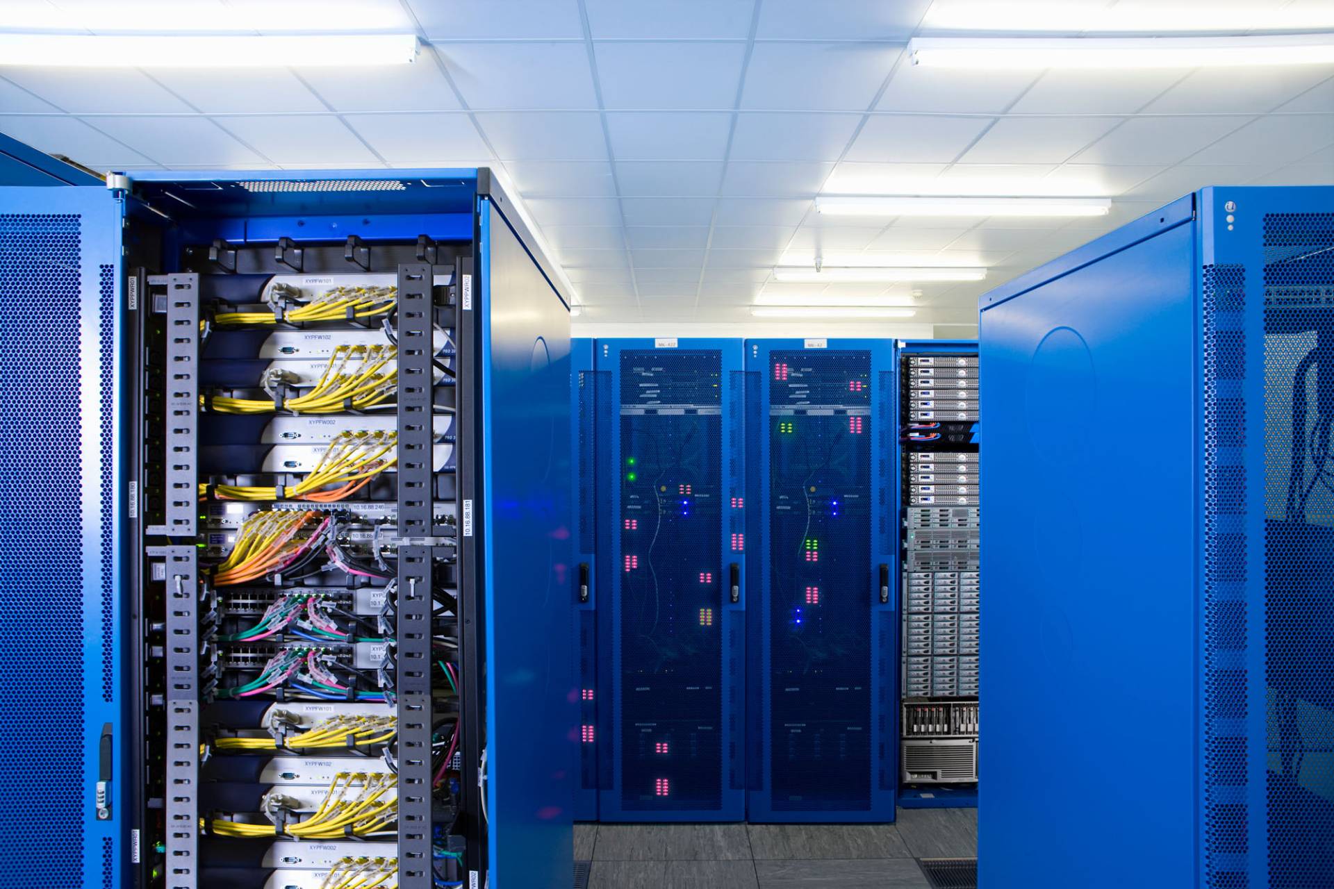 Server racks with blue cables supporting collaborative Exchange hosting