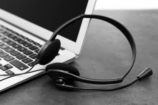 Sharp Innovations support — professional help desk headset on desk